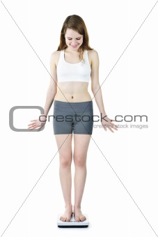 Fit young girl checking her weight