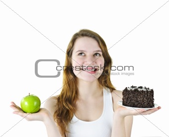 Young girl holding apple and cake