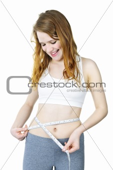 Healthy girl measuring her waist