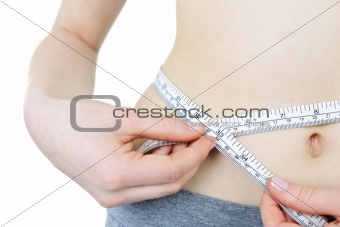 Healthy girl measuring her waist