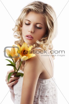 blond curly woman holding lily