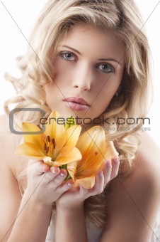 blond curly woman holding lily