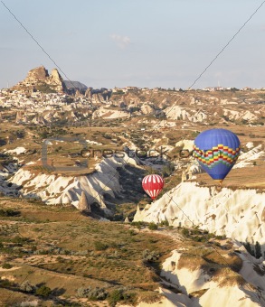 low flying balloons in ravine Uchisar Turkey