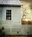 Old farm  house with pumpkin in the window