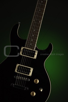 Black Electric Guitar on Green