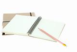 Isolated Light cream color paper note book on brown book and pen