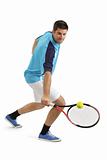 Male tennis player hitting the ball