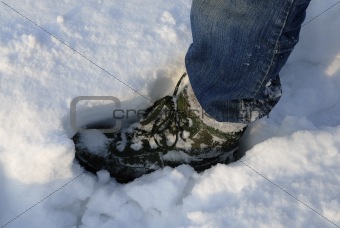 Mans boot making print in deep snow.