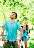 Young happy couple riding a bicycle