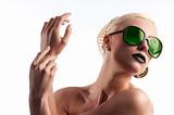 fashion shot of blond girl with green sunglasses