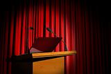 Seminar podium and red curtain