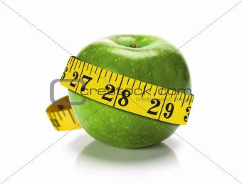 Green apple with measure tape