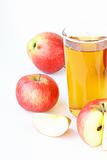 Apple juice in glass and fresh apples on white background
