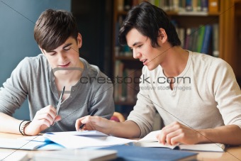 Handsome student working on an essay