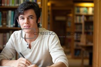 Student holding a pen