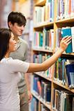 Portrait of students choosing a book on a shelf