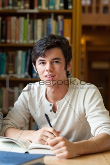 Handsome student reviewing his notes