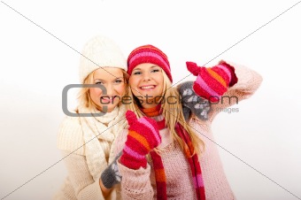 Two pretty happy winter girls friends having fun
