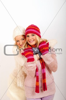 Two pretty happy winter girls friends having fun