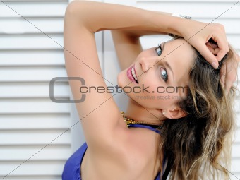 Beautiful portrait of summer sexy girl near white window