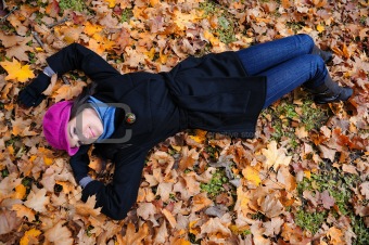 Pretty autumn girl relaxing outdoors in the forest