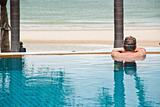 Man in swimming pool relaxing
