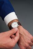 worker adjusts wristwatch