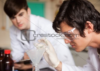 Close up of students in chemistry making an experiment
