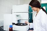 Cute scientist using a centrifuge