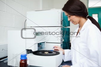 Cute scientist using a centrifuge