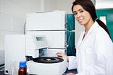 Female scientist using a centrifuge