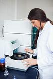 Focused scientist using a centrifuge