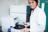 Serious laboratory assistant using a centrifuge