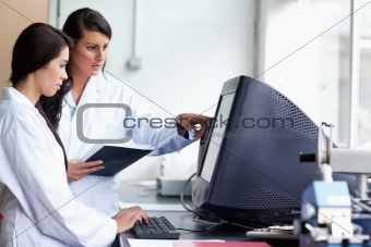 Female scientists looking at a monitor