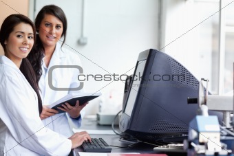 Smiling female scientist posing with a monitor