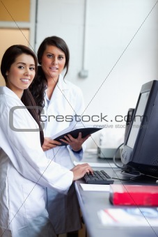 Portrait of female scientist posing with a monitor
