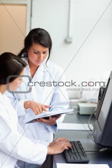 Portrait of serious scientists looking at a report