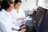 Female scientists working with a monitor