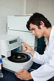 Portrait of a a student using a centrifuge