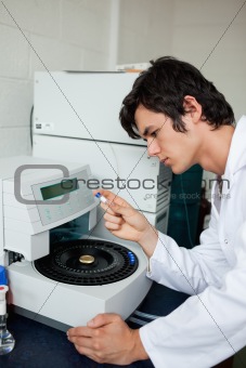 Portrait of a a student using a centrifuge