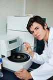 Portrait of a a student posing with a centrifuge