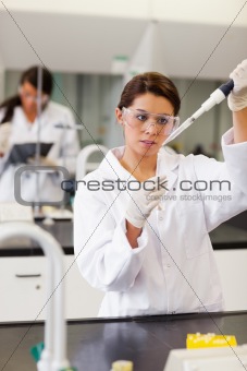 Portrait of a focused student pouring liquid in a tube