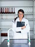 Portrait of a female scientist holding a clipboard