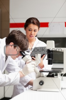 Portrait of a science student looking in a microscope