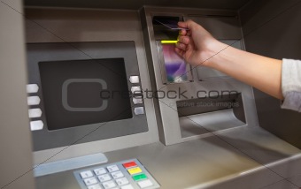 Hand inserting a credit card