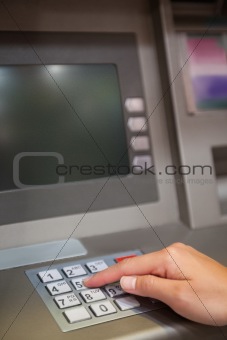 Portrait of a hand typing a PIN code