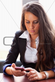 Young woman dialing on her smartphone