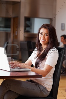Portrait of a smiling woman using a notebook