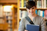 Smiling young student holding a book
