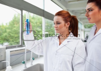 Science students looking at a graduated cylinder